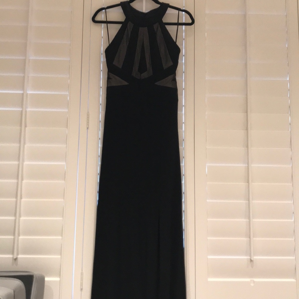 Full length black dress with slit on the left leg.